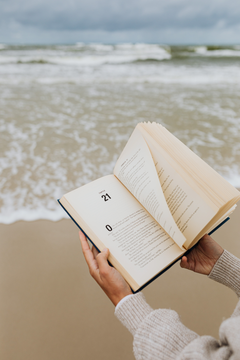 Reading at the beach with waves.