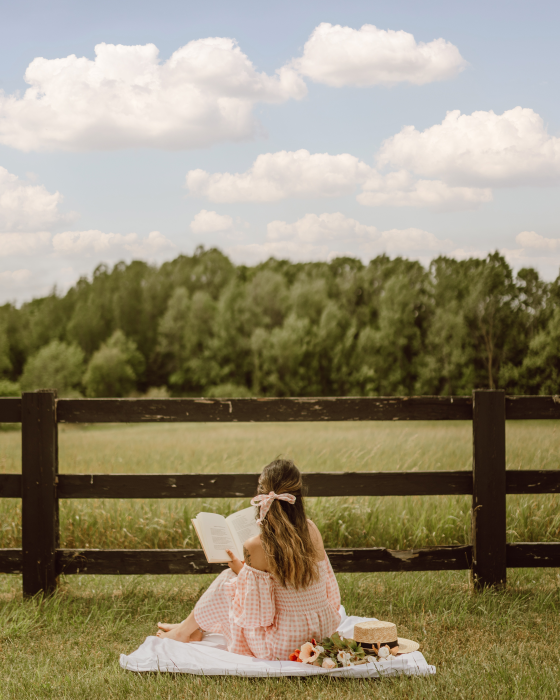 Beautiful girl wearing a summer dress having a picnic.