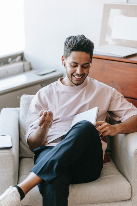 how to promote a self-published book (flyintobooks.com). Man with book smiling.